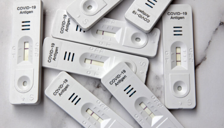 A photo of a pile of covid-19 at-home tests.