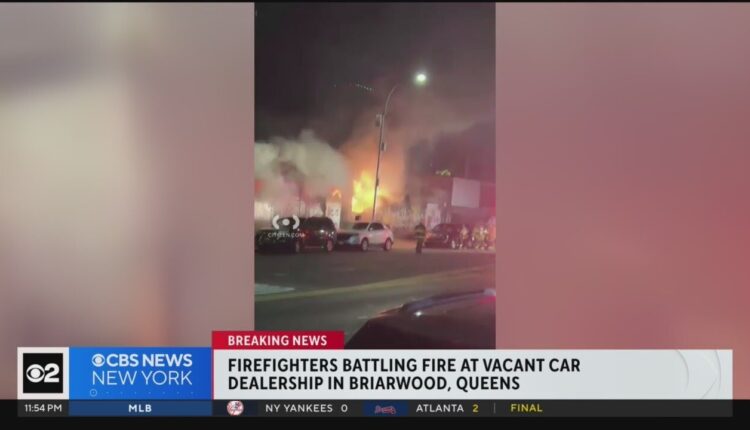 Firefighters battling fire at vacant car dealership in Queens