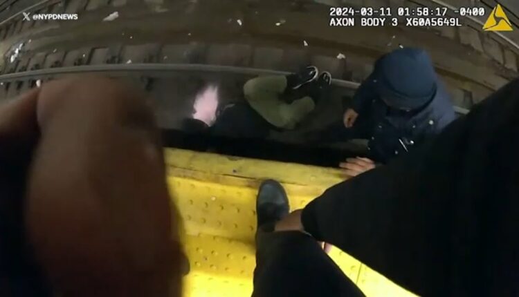 Videos shows officers rescuing man who fell on tracks
